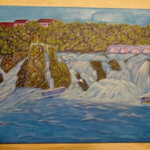 Water cascading over rocks with trees and buildings beyond in Rhine Falls by Raisa Rehuretska.