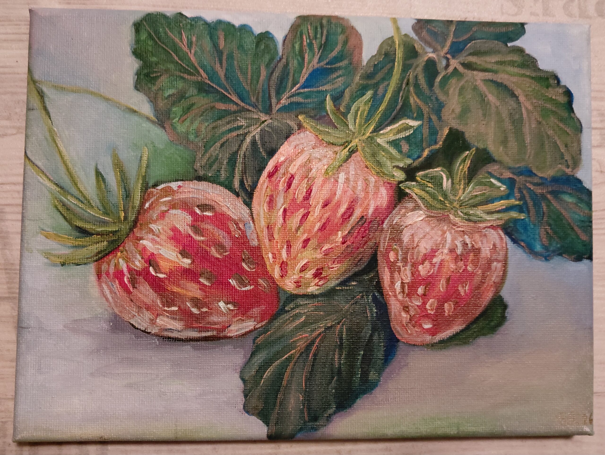 Ripe strawberries with green leaves on a pale surface in Mom's Strawberries by Raisa Rehuretska.